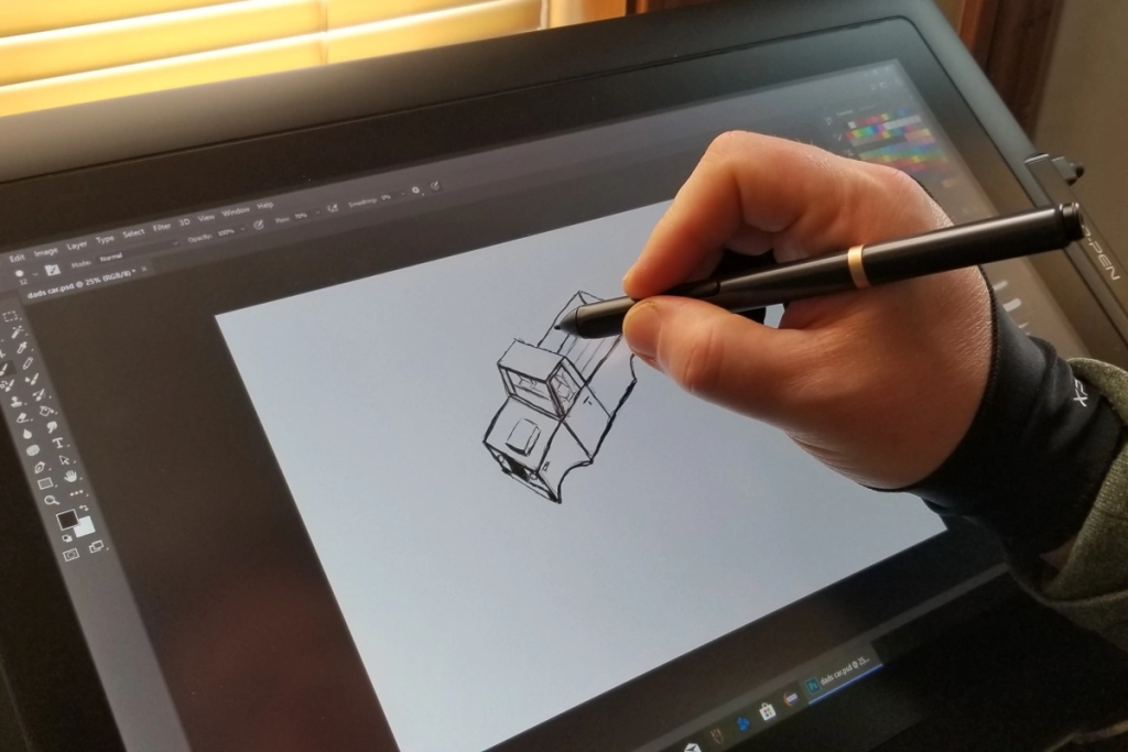 An artist’s hand drawing on a digital tablet screen to teach how to make digital art techniques.