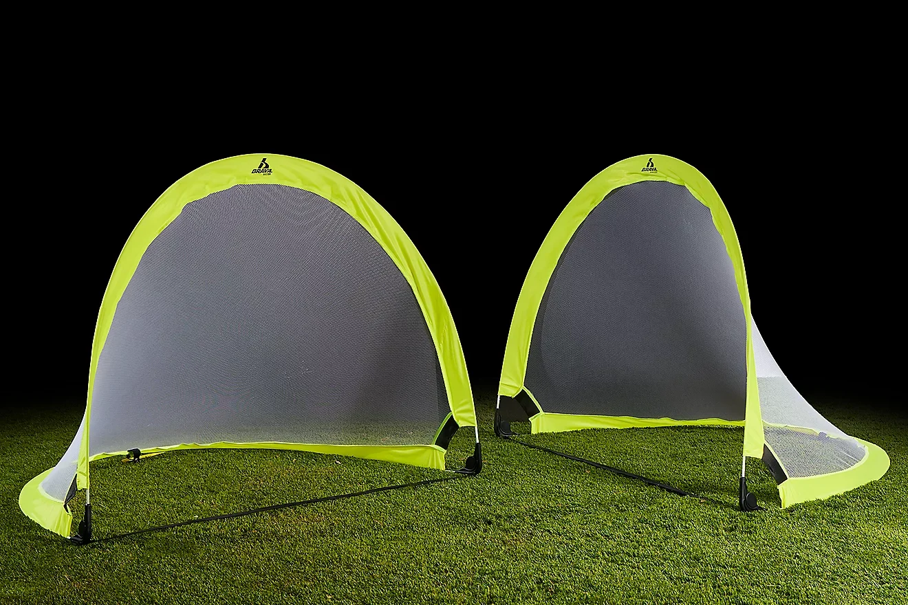 Neon yellow collapsible soccer goals set up on grass for a training session.
