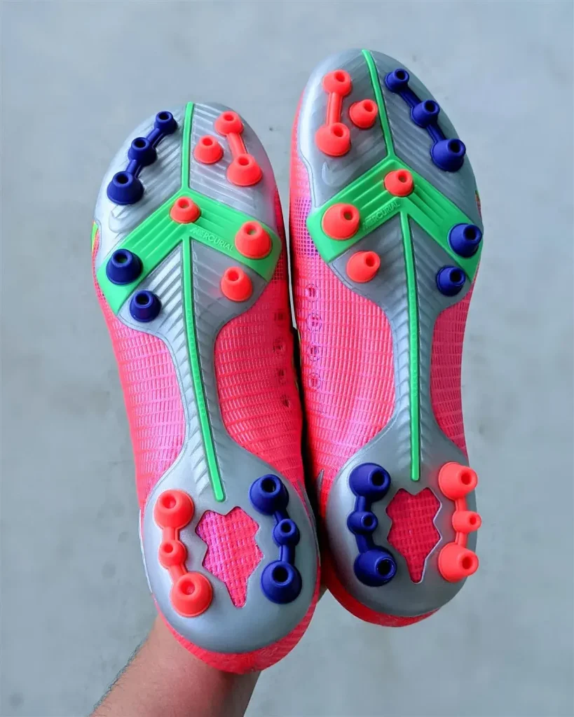 High-performance artificial ground soccer shoes with specialized impact-reducing traction.