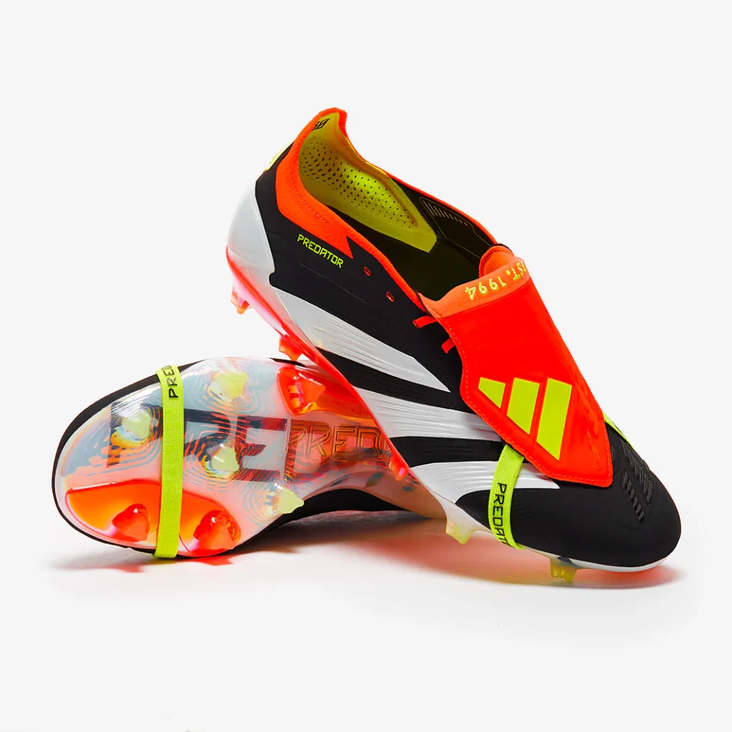 Red and black Adidas Predator boots with the iconic fold-over tongue and elastic strap.